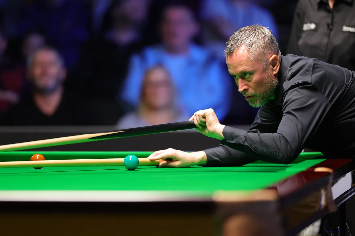 A player addresses the cue ball during competition in Belfast