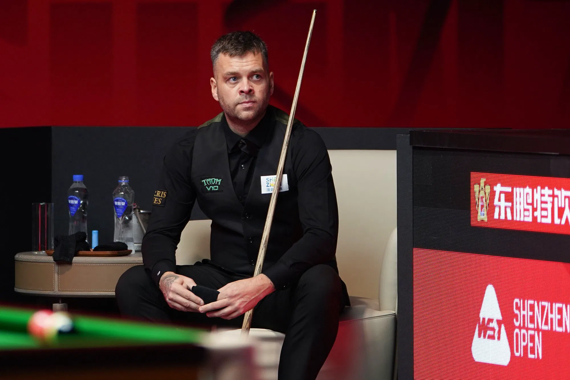 Chris Wakelin watches from his chair during the Shenzhen Open quarterfinal