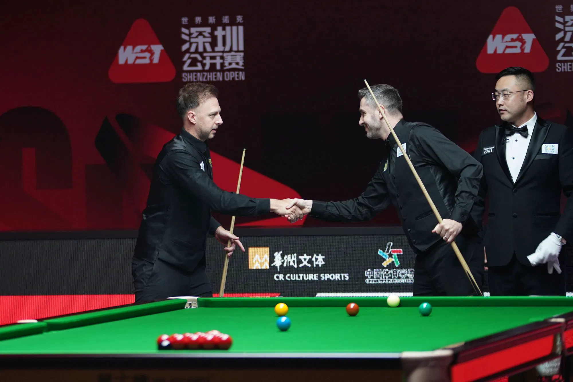 Judd Trump and Mark Selby shake hands after their Shenzhen Open quarterfinal