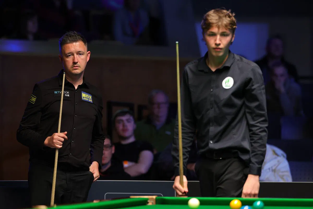 Players wait beside the table during the Belfast session