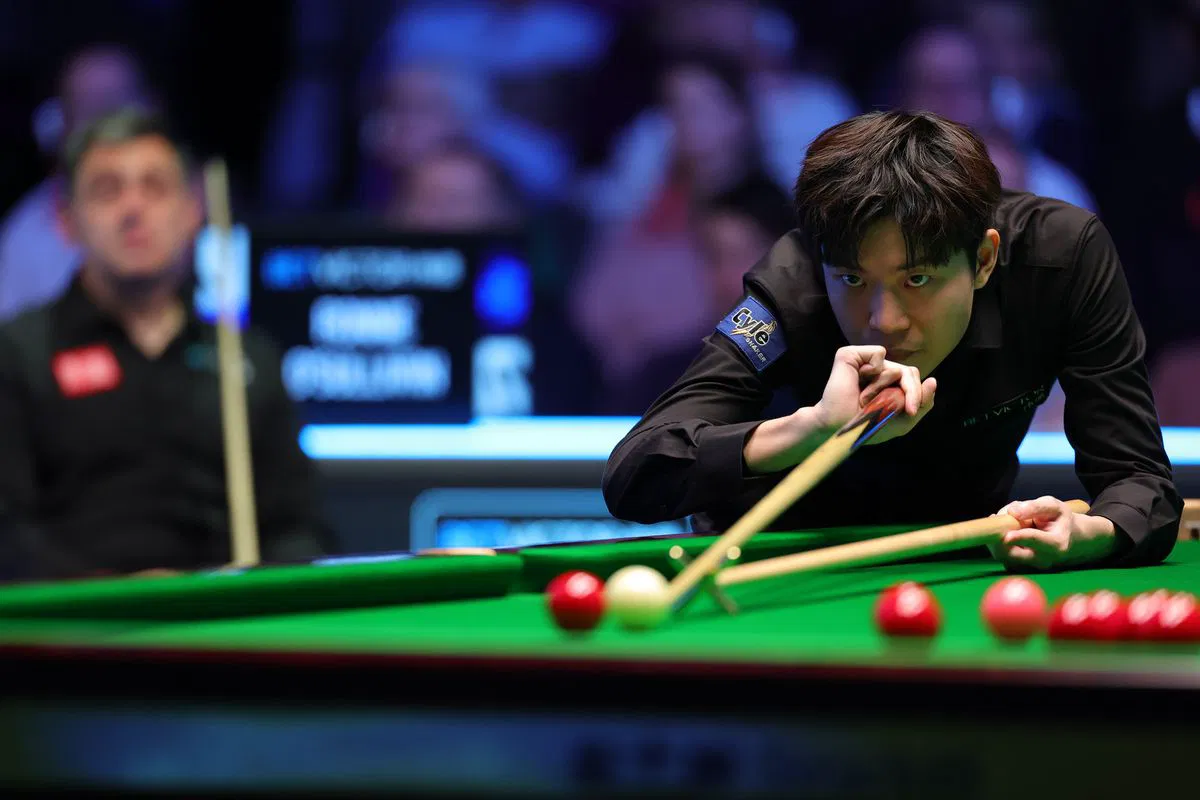 Ka Wai Cheung lines up a shot in Belfast